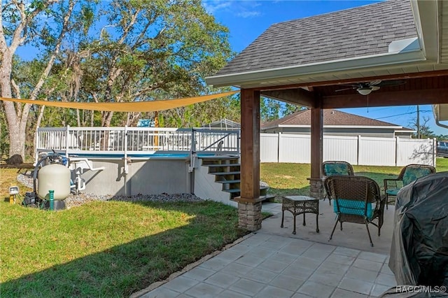 view of patio / terrace with a fenced in pool, ceiling fan, fence, a wooden deck, and stairs