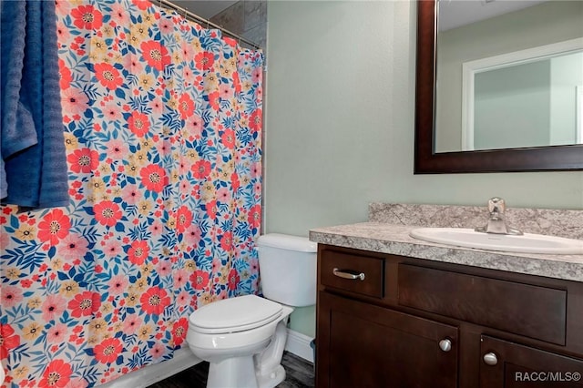 bathroom featuring vanity and toilet