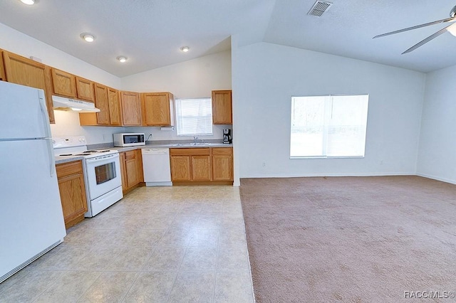 kitchen with lofted ceiling, sink, white appliances, ceiling fan, and light colored carpet