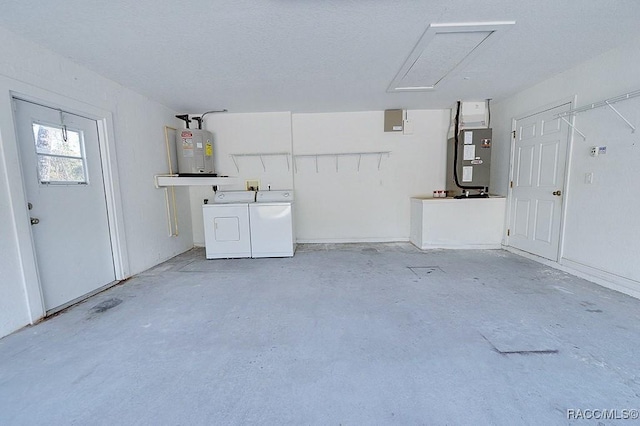 garage featuring independent washer and dryer and electric water heater