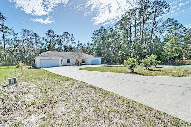 ranch-style house featuring a garage and a front lawn