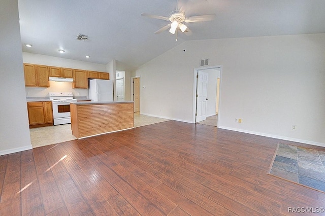 kitchen with white appliances, vaulted ceiling, light hardwood / wood-style floors, and ceiling fan