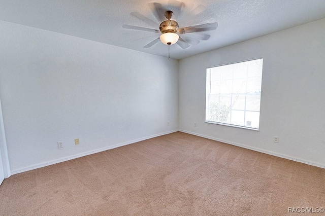 unfurnished room featuring light carpet, a textured ceiling, and ceiling fan