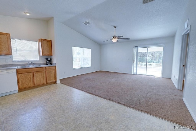 kitchen with dishwasher, lofted ceiling, sink, light colored carpet, and ceiling fan