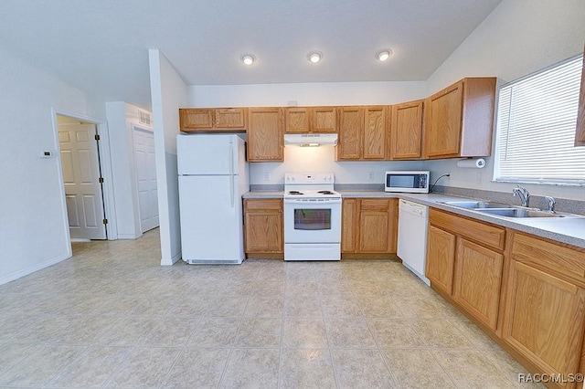 kitchen with vaulted ceiling, white appliances, and sink