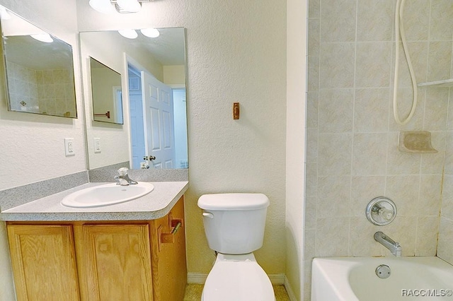 full bathroom featuring tiled shower / bath combo, vanity, and toilet