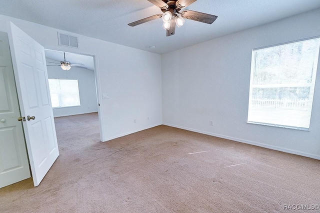 carpeted spare room with ceiling fan and lofted ceiling