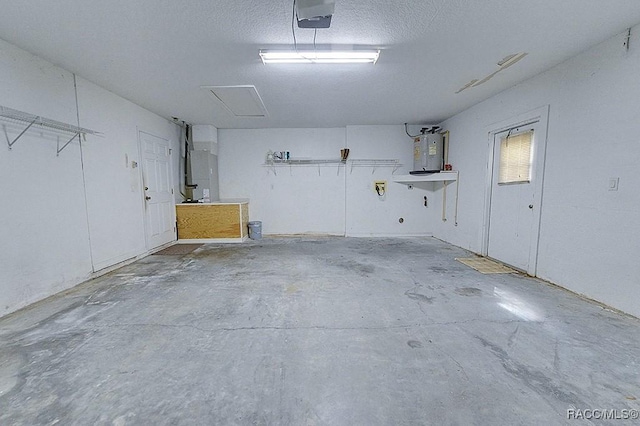 garage with a garage door opener and electric water heater