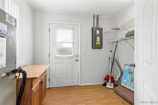 entryway featuring light wood-style floors, electric panel, and ornamental molding