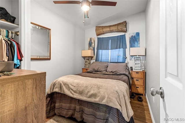 bedroom featuring a ceiling fan, baseboards, and wood finished floors