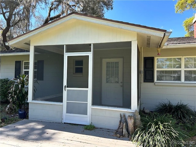 doorway to property featuring concrete block siding