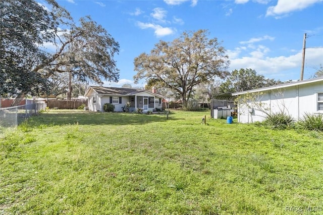 view of yard featuring a carport and fence