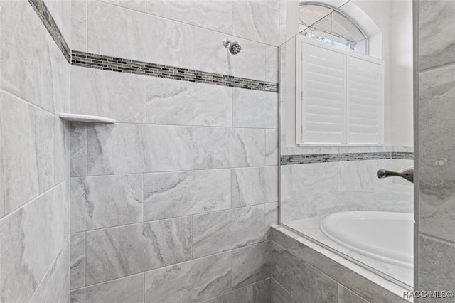 bathroom with a tile shower