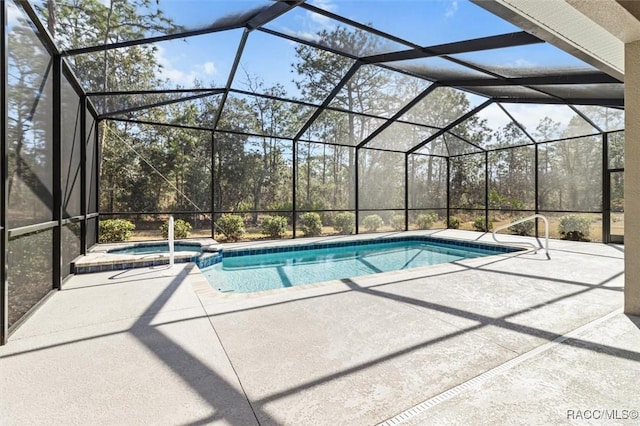 view of swimming pool with an in ground hot tub, a lanai, and a patio area