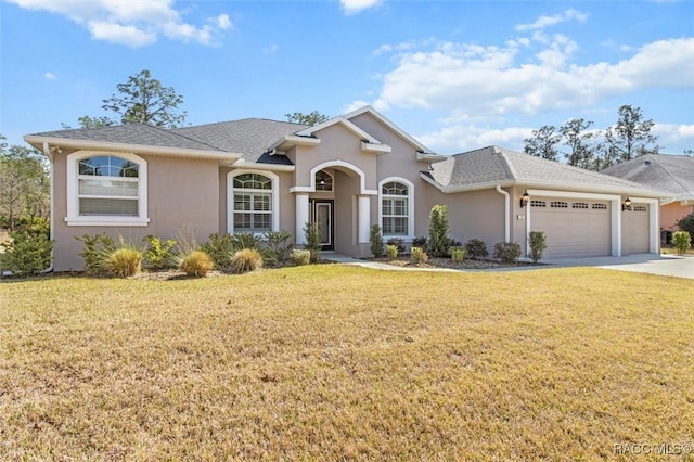 view of front of house with a garage and a front lawn