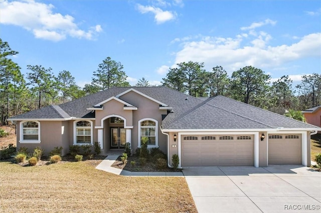 ranch-style house featuring a garage and a front lawn