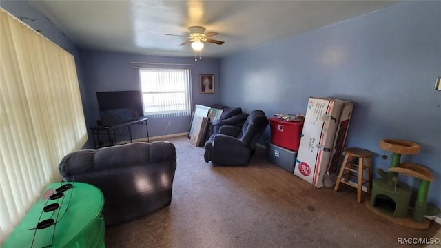 interior space with carpet flooring and ceiling fan