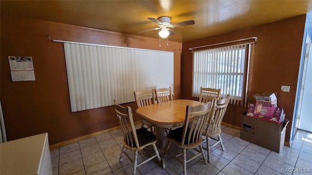 dining room with ceiling fan and light tile patterned flooring