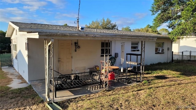 back of house featuring a yard and cooling unit