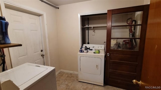 washroom featuring washer and dryer and light tile patterned floors