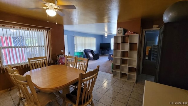 tiled dining room featuring ceiling fan