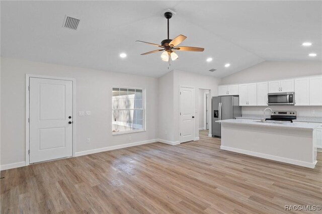 6658 N Bedstrow Blvd, Dunnellon, FL 34434 - kitchen with stainless steel appliances, vaulted ceiling, light countertops, ceiling fan, and white cabinetry