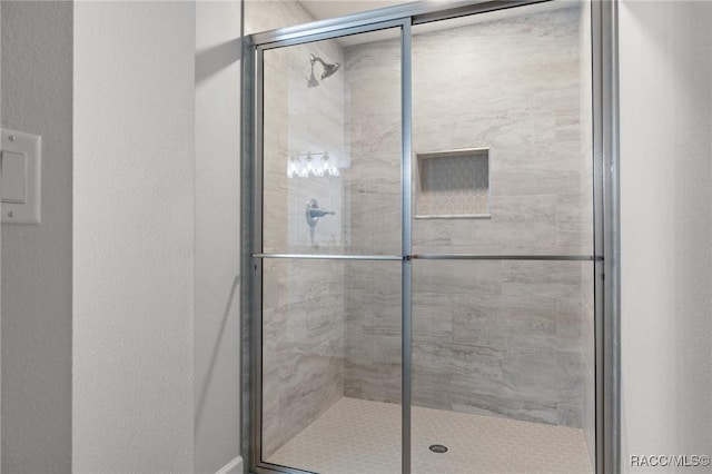 6658 N Bedstrow Blvd, Dunnellon, FL 34434 - bathroom featuring a stall shower and a textured wall