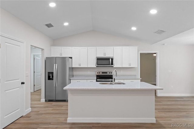 6658 N Bedstrow Blvd, Dunnellon, FL 34434 - kitchen with appliances with stainless steel finishes, lofted ceiling, white cabinetry, light countertops, and recessed lighting