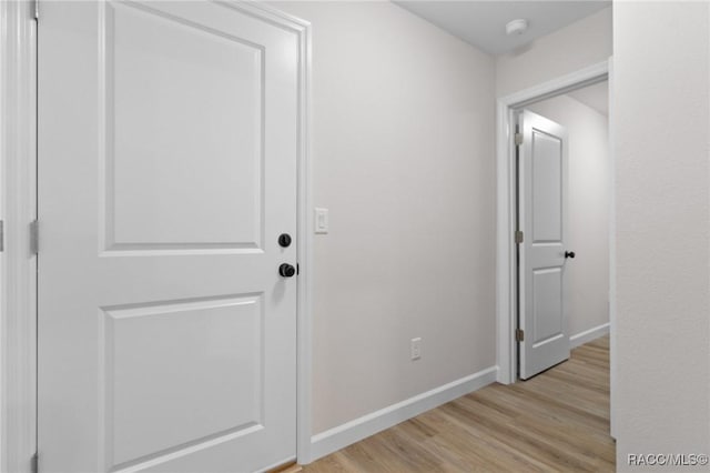 6658 N Bedstrow Blvd, Dunnellon, FL 34434 - hallway with light wood-style flooring and baseboards