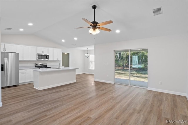 6658 N Bedstrow Blvd, Dunnellon, FL 34434 - kitchen featuring appliances with stainless steel finishes, vaulted ceiling, open floor plan, white cabinets, and a ceiling fan
