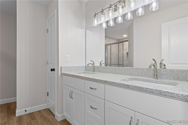 6658 N Bedstrow Blvd, Dunnellon, FL 34434 - full bath featuring a stall shower, wood finished floors, and double vanity