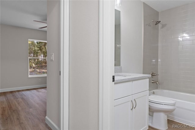 6658 N Bedstrow Blvd, Dunnellon, FL 34434 - bathroom with vanity, wood finished floors, bathing tub / shower combination, and a ceiling fan
