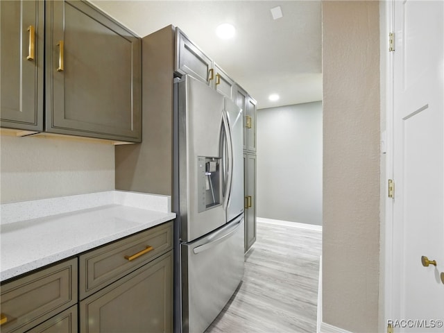 34 S Harrison St, Beverly Hills, FL 34465 - kitchen featuring stainless steel refrigerator with ice dispenser, baseboards, light wood-style flooring, recessed lighting, and light stone countertops