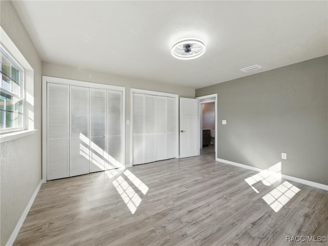 34 S Harrison St, Beverly Hills, FL 34465 - unfurnished bedroom with multiple closets, light wood-style flooring, and baseboards