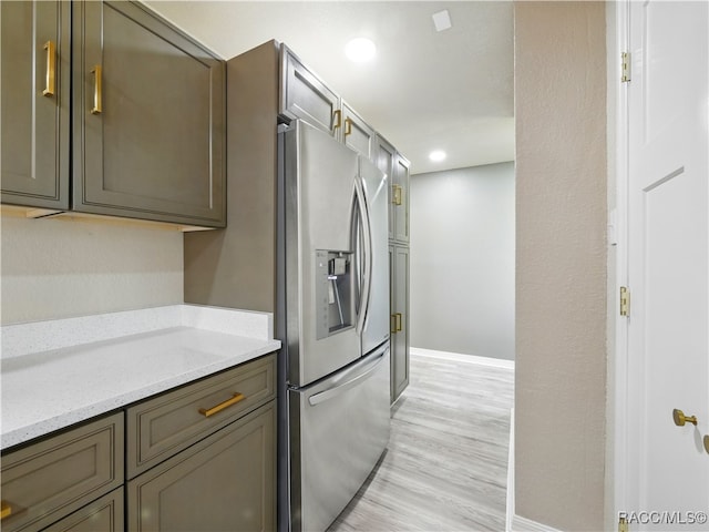 34 S Harrison St, Beverly Hills, FL 34465 - kitchen featuring stainless steel fridge, baseboards, light wood-style flooring, light stone counters, and recessed lighting