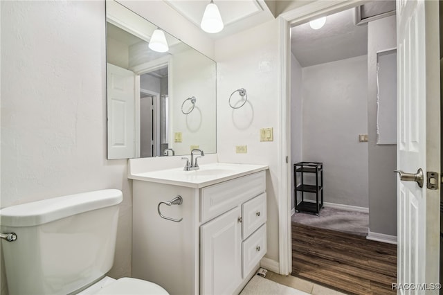 bathroom featuring hardwood / wood-style floors, vanity, and toilet