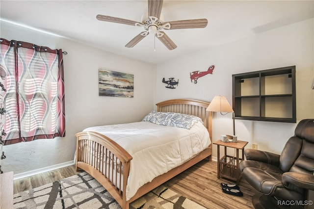 bedroom featuring light hardwood / wood-style floors and ceiling fan