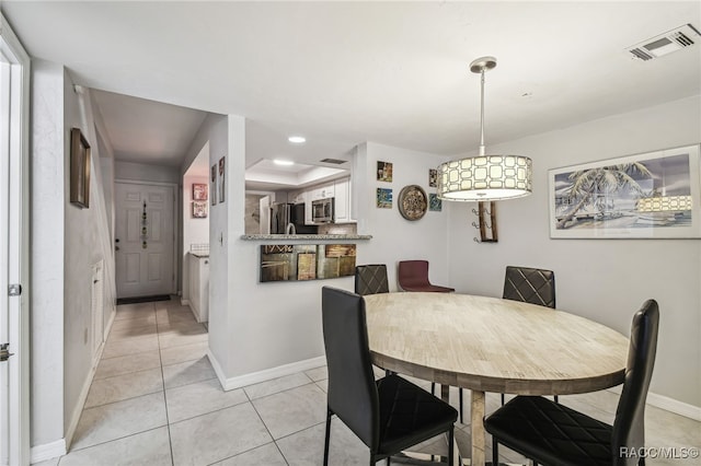 dining space featuring light tile patterned floors