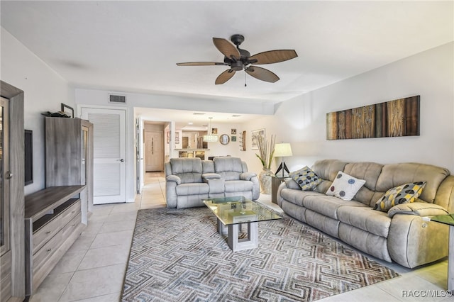 living room with ceiling fan and light tile patterned flooring