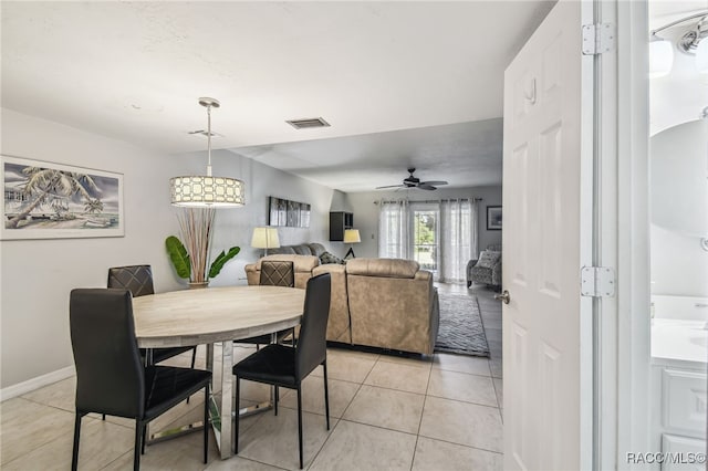 tiled dining space featuring ceiling fan