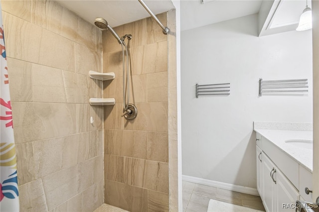 bathroom featuring tile patterned flooring, vanity, and walk in shower