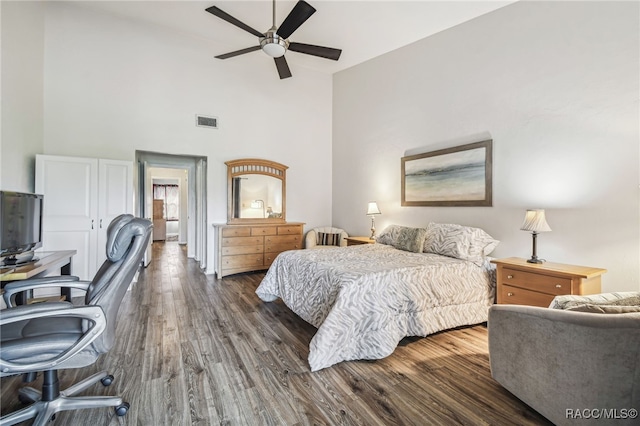 bedroom featuring ceiling fan, dark wood-type flooring, and high vaulted ceiling