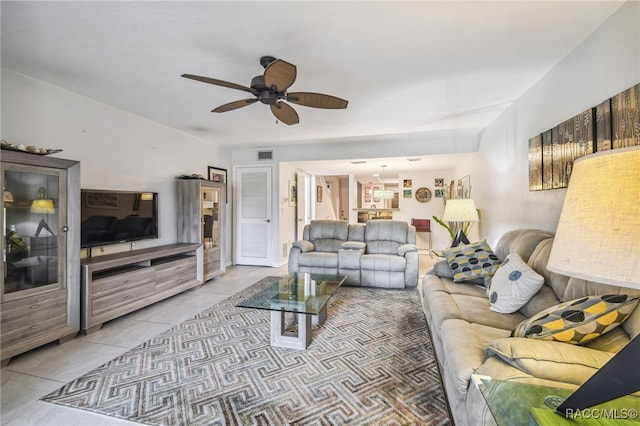 tiled living room with ceiling fan