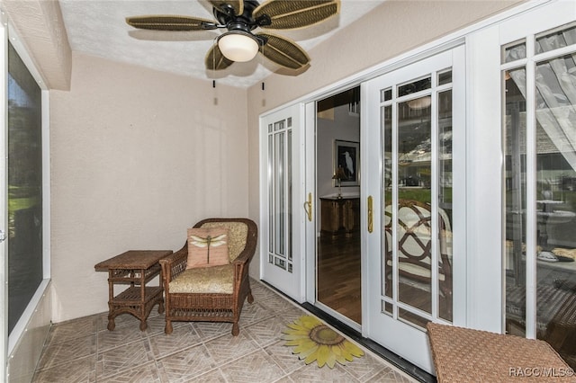 sunroom / solarium with ceiling fan and french doors