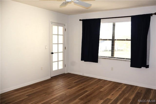 empty room featuring dark hardwood / wood-style flooring and ceiling fan