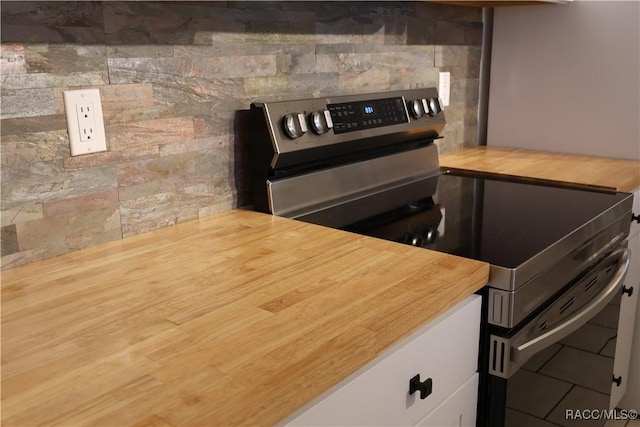 kitchen featuring tile patterned flooring and stainless steel stove