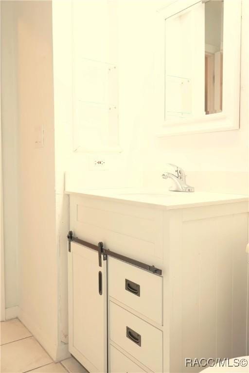 bathroom featuring tile patterned flooring and vanity