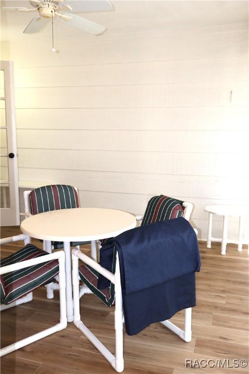 dining space with hardwood / wood-style floors and ceiling fan