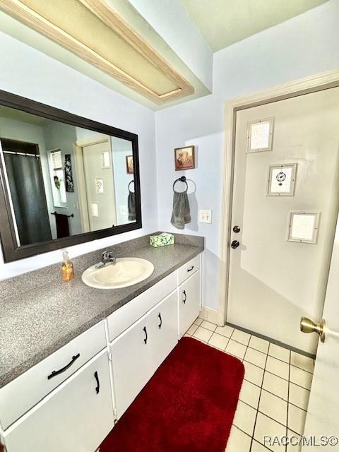 bathroom featuring tile patterned flooring and vanity