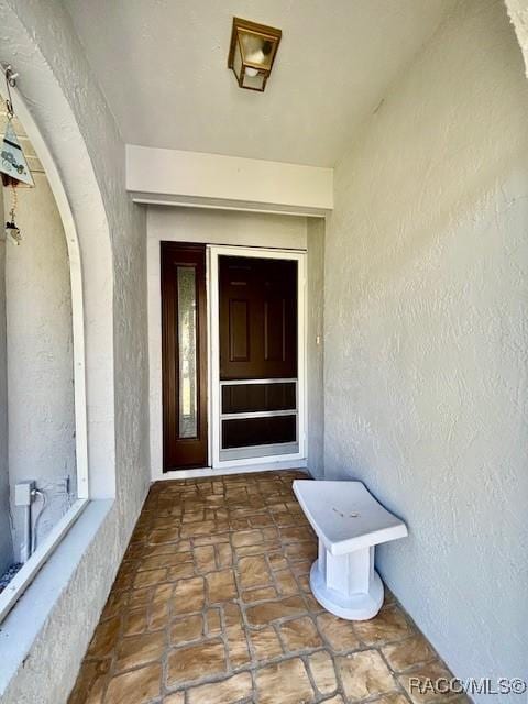 property entrance with stucco siding